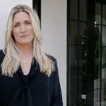 First-ever Major League Volleyball MLV commissioner Jaime Weston poses in a black shirt against a white wall.
