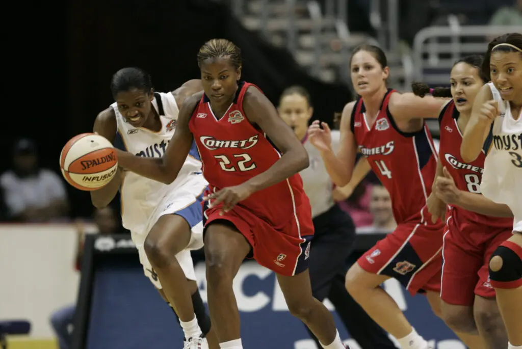 Houston Comets forward Sheryl Swoopes races the ball up the court during a 2006 WNBA game against the Washington Mystics.