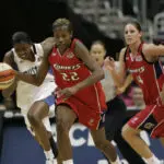Houston Comets forward Sheryl Swoopes races the ball up the court during a 2006 WNBA game against the Washington Mystics.