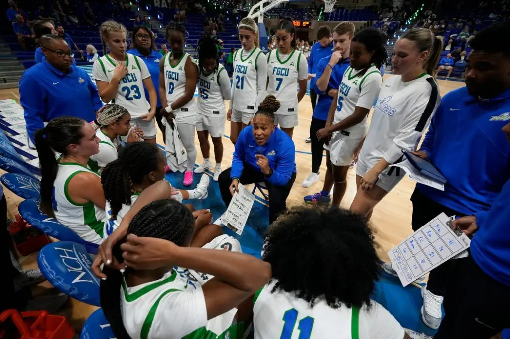 FGCU head coach Raina Harmon talks to her team during a timeout .The Florida Gulf Coast University women's basketball team opened their season Saturday, Nov. 8, as the lady Eagles faced off against Davidson College Wildcats at Alico Arena. Davidson walked away with the victory with a final score of 77-51.