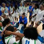 FGCU head coach Raina Harmon talks to her team during a timeout .The Florida Gulf Coast University women's basketball team opened their season Saturday, Nov. 8, as the lady Eagles faced off against Davidson College Wildcats at Alico Arena. Davidson walked away with the victory with a final score of 77-51.