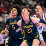 West Virginia forward Riley Makalusky and guard Sydney Shaw box out TCU guard Donovyn Hunter as they all eye a rebound during the 2026 Big 12 women's basketball tournament championship game.