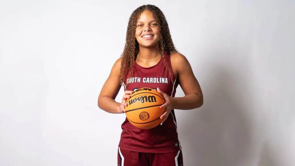 High School recruit Jerzy Robinson poses for a portrait wearing a South Carolina jersey and holding a basketball.