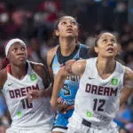 Rhyne Howard #10 of the Atlanta Dream, Nia Coffey #12 of the Atlanta Dream guard Angel Reese #5 of the Chicago Sky during a free throw during a game between the Chicago Sky and Atlanta Dream at Gateway Center Arena on June 22, 2025 in College Park, Georgia.