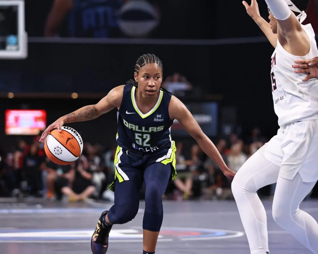 Tyasha Harris #52 of the Dallas Wings handles the ball during the game against the Atlanta Dream on May 24, 2025 at Gateway Center Arena at College Park in Atlanta, Georgia.