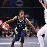 Tyasha Harris #52 of the Dallas Wings handles the ball during the game against the Atlanta Dream on May 24, 2025 at Gateway Center Arena at College Park in Atlanta, Georgia.