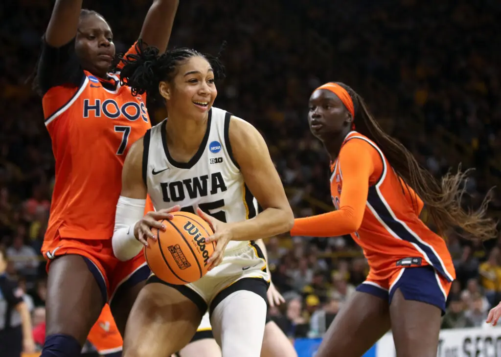 Forward Hannah Stuelke #45 of the Iowa Hawkeyes goes to the basket in the second half against forward Tabitha Amanze #7 and forward Adeang Ring #8 of the Virginia Cavaliers on March 23, 2026 at Carver-Hawkeye Arena during the second round of the NCAA Women's Basketball Tournament, in Iowa City, Iowa.