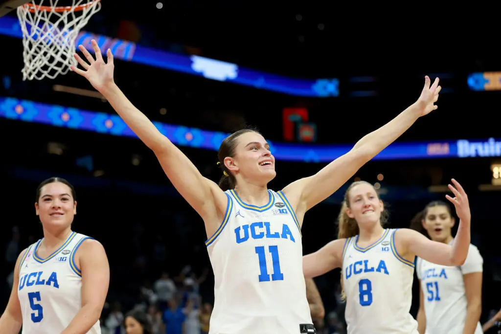 Charlisse Leger-Walker #5, Gabriela Jaquez #11, and Gianna Kneepkens #8 of the UCLA Bruins celebrate after the victory against the Texas Longhorns in the Final Four of the NCAA Women's Basketball Tournament at Mortgage Matchup Center on April 03, 2026 in Phoenix, Arizona.