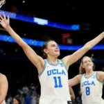 Charlisse Leger-Walker #5, Gabriela Jaquez #11, and Gianna Kneepkens #8 of the UCLA Bruins celebrate after the victory against the Texas Longhorns in the Final Four of the NCAA Women's Basketball Tournament at Mortgage Matchup Center on April 03, 2026 in Phoenix, Arizona.