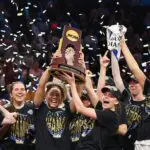 Kiki Rice #1 and Gabriela Jaquez #11 of the UCLA Bruins celebrate with the trophy after the victory against the South Carolina Gamecocks in the National Championship of the NCAA Women's Basketball Tournament at Mortgage Matchup Center on April 05, 2026 in Phoenix, Arizona.