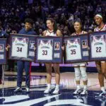 UConn women's basketball forward Ice Brady (25), forward Ayanna Patterson (34), guard Caroline Ducharme (33), guard Azzi Fudd (35) and forward Serah Williams (22) hold up their jerseys during senior night after defeating the Providence Friars at Harry A. Gampel Pavilion.