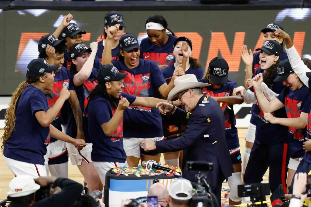 UConn Huskies head coach Geno Auriemma dances with his team after the UConn Huskies are awarded the Fort Worth Regional trophy following their win against the Notre Dame Fighting Irish at Dickies Arena.