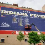 The 2026 Indiana Fever mural gets a touch up on Wednesday, April 29, 2026, in Indianapolis displaying where to watch Dallas Wings vs Indiana Fever WNBA preseason game.