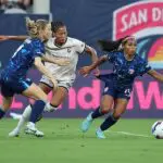 C is challenged by Sveindis Jane Jonsdottir #32 of Angel City FC during the NWSL match between San Diego Wave and Angel City FC at Snapdragon Stadium on August 09, 2025 in San Diego, California.