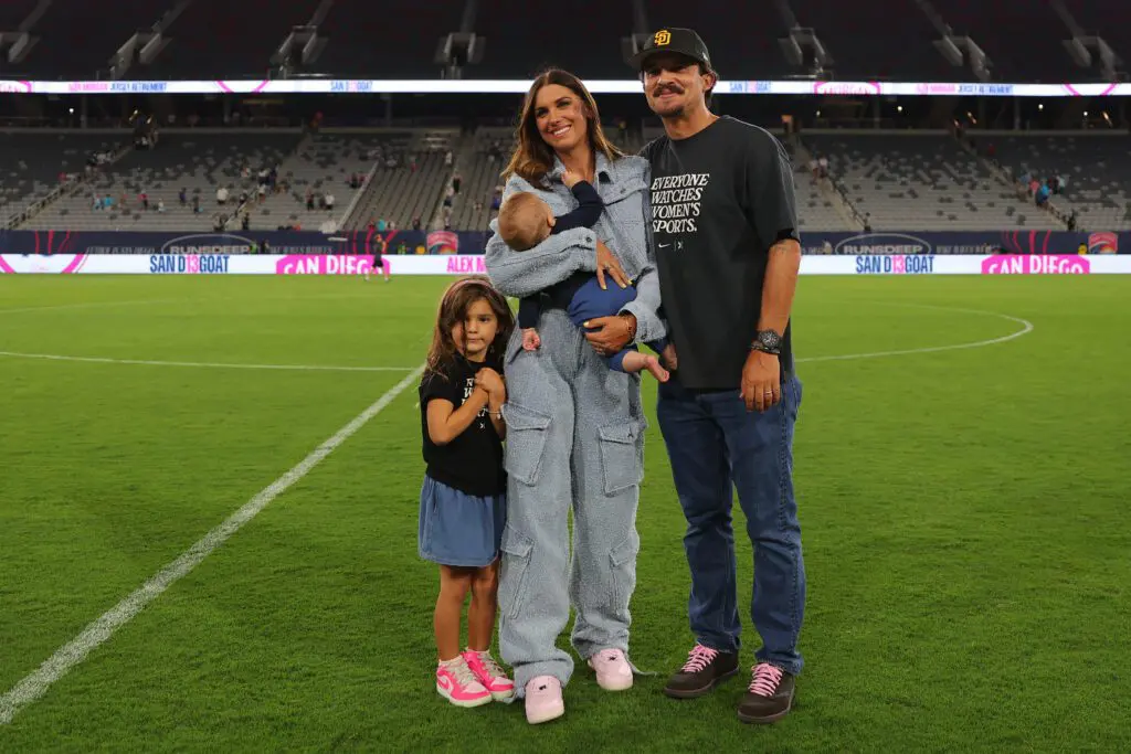 Alex Morgan poses with her husband, Servando Carrasco, and children during the ceremony to retire Morgan's Number 13 jersey following NWSL match between San Diego Wave and Houston Dash at Snapdragon Stadium