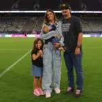 Alex Morgan poses with her husband, Servando Carrasco, and children during the ceremony to retire Morgan's Number 13 jersey following NWSL match between San Diego Wave and Houston Dash at Snapdragon Stadium