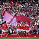 Olivia Smith of Arsenal celebrates scoring her team's second goal with teammates during the UWCL Women's Champions League 2025/26 Semifinal First Leg match between Arsenal FC and OL Lyonnes at Arsenal Stadium on April 26, 2026 in London, England.