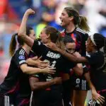 UWCL Lyon’s German forward #29 Jule Brand (C) celebrates with teammates after scoring a goal during the women’s UEFA Champions League second-leg semi-final football match between OL Lyonnes and Arsenal at the Groupama Stadium, in Decines-Charpieu, central-eastern France on May 2, 2026.
