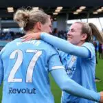 Lauren Hemp of Manchester City WSL embraces teammate Rebecca Knaak as she is presented with the Barclays Women's Super League Player of the Match trophy following the Barclays Women's Super League match between Manchester City and Liverpool at Joie Stadium on May 03, 2026 in Manchester, England.