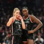 Sarah Ashlee Barker #3 and Nyadiew Puoch #13 of the Portland Fire talk over a play during a free throw in the first half go the game against the New York Liberty at Moda Center on May 14, 2026 in Portland, Oregon.