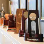NCAA women's golf championship trophies are displayed from the various championships by both the men and women in the new Crimson Reserve golf training facility at the University of Alabama Friday, Oct. 11, 2024.