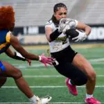 Alabama State's Jasmine Dunn (2) carries against Andrew College during their flag football game on the ASU campus in Montgomery, Ala.