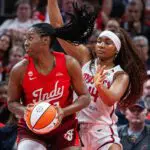 Indiana Fever center-forward Aliyah Boston (7) shoots the ball while Washington Mystics forward Kiki Iriafen (44) defends in the first half at Gainbridge Fieldhouse.