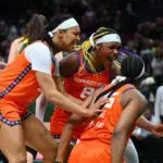 Connecticut Sun forward Nell Angloma (33) and forward Aaliyah Edwards (8) celebrate with guard Kennedy Burke (25) after Burke scored a basket to take the lead with 2.8 second left in the game against the Seattle Storm.