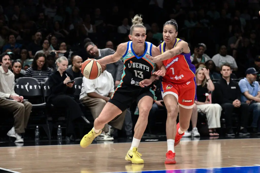 New York Liberty forward Leonie Fiebich (13) tries to drive past Phoenix Mercury forward Noemie Brochant (1) during the first half at Barclays Center.