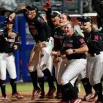 Nebraska celebrates the home run of Hannah Coor (23) in the eighth inning during a Women's College World Series softball game between the Arkansas Razorbacks and the Nebraska Cornhuskers at Devon Park in Oklahoma City.