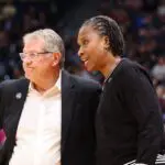 UConn Huskies assistant coach Jamelle Elliott speaks with UConn Huskies head coach Geno Auriemma during the 2025 NCAA Div I Women's Championship Final Four game between UConn Huskies and UCLA Bruins.