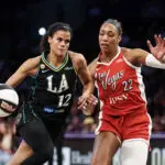 Rae Burrell #12 of the Los Angeles Sparks handles the ball against A'ja Wilson #22 of the Las Vegas Aces in the first half at Crypto.com Arena.