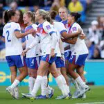 Jess Carter of England celebrates scoring her team's first goal with teammates during the FIFA Women's World Cup 2027 Qualifier match between England and Ukraine.