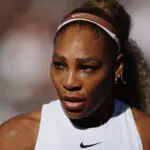 Serena Williams of the United States looks on with Victoria Mboko of Canada (out of frame) against Nicole Melichar-Martinez of the United States and Erin Routliffe of New Zealand during the Women's Doubles first round match on Day Two of the HSBC Championships at The Queen's Club.