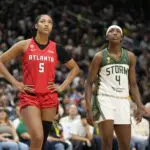 Flau'jae Johnson #4 of the Seattle Storm and Angel Reese #5 of the Atlanta Dream look on during the game on June 27, 2026 at Climate Pledge Arena.