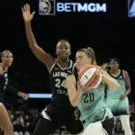 New York Liberty guard Sabrina Ionescu (20) drives against Las Vegas Aces guard Jewell Loyd (24) during the fourth quarter of their game at Michelob Ultra Arena.