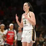 Indiana Fever guard Caitlin Clark (22) reacts after making a three-point basket against the Washington Mystics during the first quarter at CareFirst Arena.