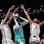 New York Liberty center Jonquel Jones (35) tries to get past Washington Mystics center Lauren Betts (51) and center Shakira Austin (0) during the first half at Barclays Center.
