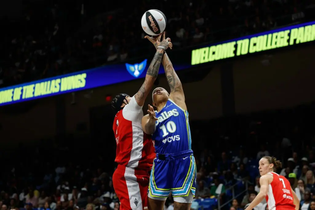 Dallas Wings guard Aziaha James (10) is fouled by Las Vegas Aces forward Kierstan Bell (1) during the second half at College Park Center ahead of the WNBA season schedule shift.