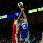Dallas Wings guard Aziaha James (10) is fouled by Las Vegas Aces forward Kierstan Bell (1) during the second half at College Park Center ahead of the WNBA season schedule shift.