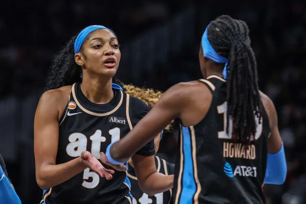 Atlanta Dream forward Angel Reese (5) high fives teammate guard Rhyne Howard (10) during the game against the Indiana Fever during the fourth quarter at State Farm Arena ahead of tonight's Dream vs Tempo WNBA game.