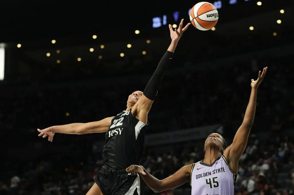 Las Vegas Aces center A'ja Wilson (22) reaches for the ball against Golden State Valkyries center Nadia Fingall (45) during the fourth quarter of a WNBA basketball game at Michelob Ultra Arena during the valkyries vs aces WNBA game.
