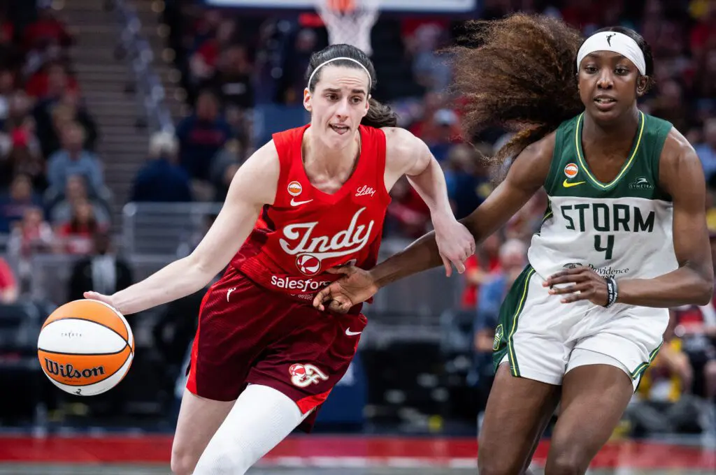 Indiana Fever guard Caitlin Clark (22) dribbles the ball against Seattle Storm guard Flau'jae Johnson (4) in the second half at Gainbridge Fieldhouse.