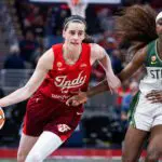 Indiana Fever guard Caitlin Clark (22) dribbles the ball against Seattle Storm guard Flau'jae Johnson (4) in the second half at Gainbridge Fieldhouse.