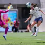 Seattle Reign FC midfielder Maddie Mercado (2) scores on a header as San Diego Wave FC goalkeeper Sandra Panos (12) defends during the first half at Snapdragon Stadium.
