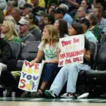 Fans hold a Indiana Fever guard Sophie Cunningham (8) (not pictured) sign during the first half between the Seattle Storm and the Indiana Fever at Climate Pledge Arena.