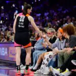 Caitlin Clark #22 of Team WNBA greets Aubrey Plaza during the second half of the 2024 WNBA All Star Game at Footprint Center on July 20, 2024 in Phoenix, Arizona.