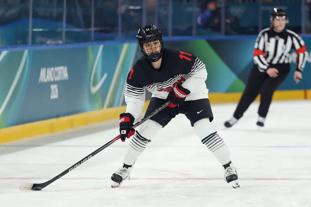 Akane Shiga #11 of Team Japan skates with the puck in the second period during the Women's Preliminary Group B match.