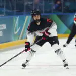 Akane Shiga #11 of Team Japan skates with the puck in the second period during the Women's Preliminary Group B match.