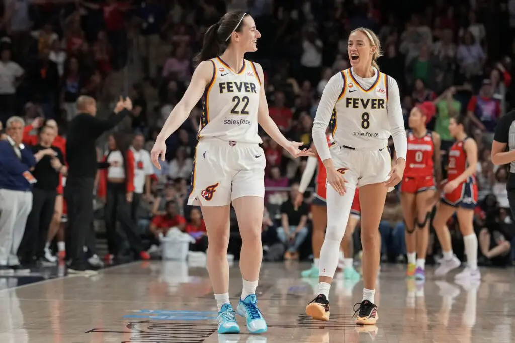 Caitlin Clark #22 of the Indiana Fever celebrates with Sophie Cunningham #8 after scoring the game-winning three pointer during the second half against the Washington Mystics.
